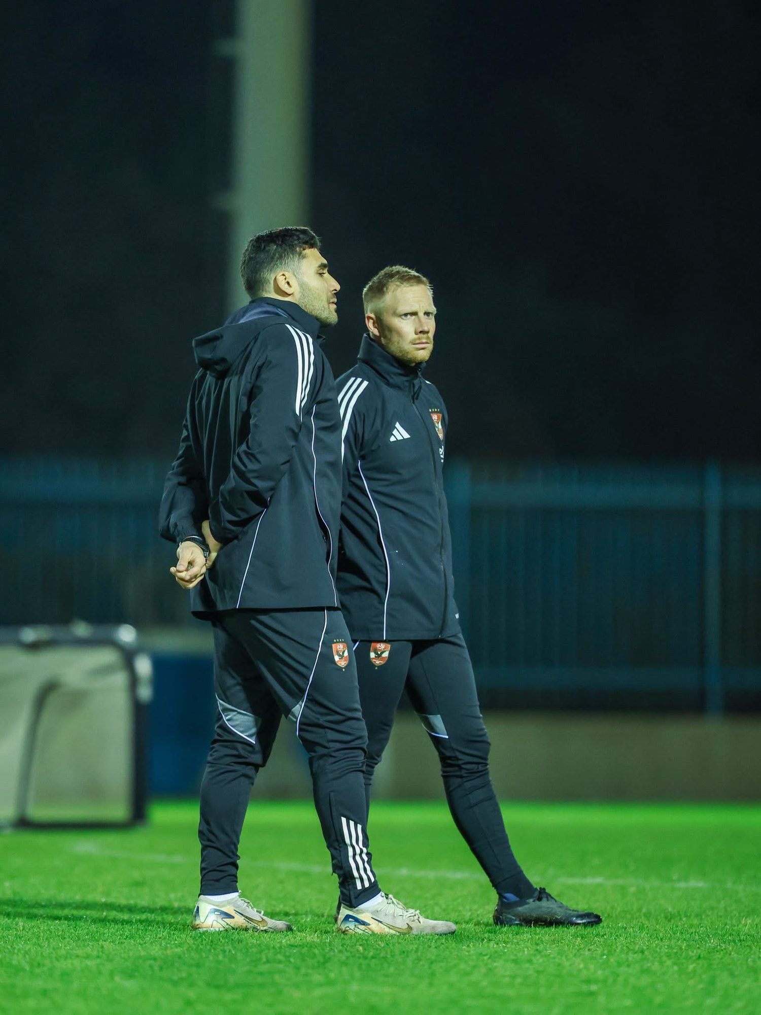 Two staff watching a night session