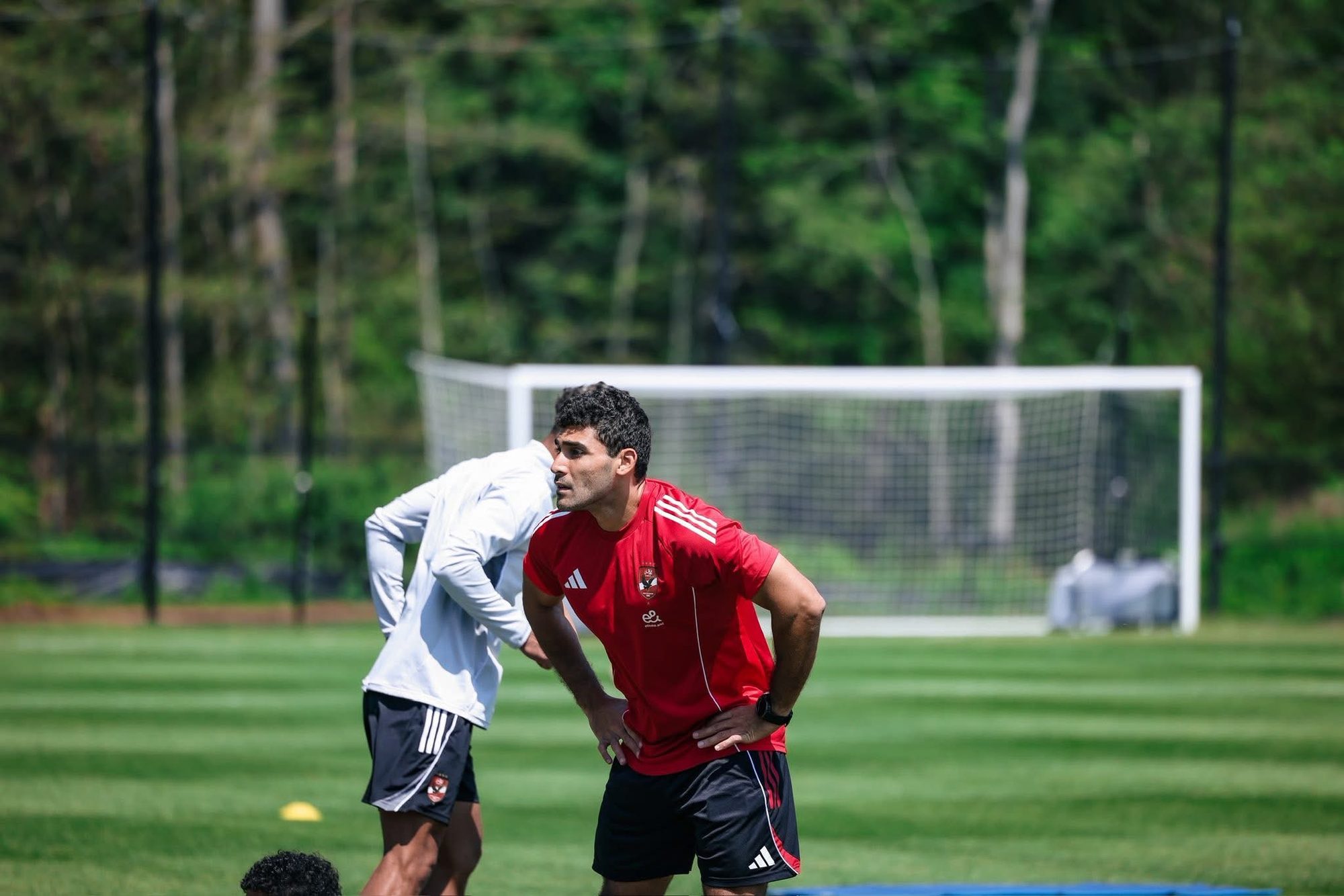 Shihy working one to one with a player on the pitch