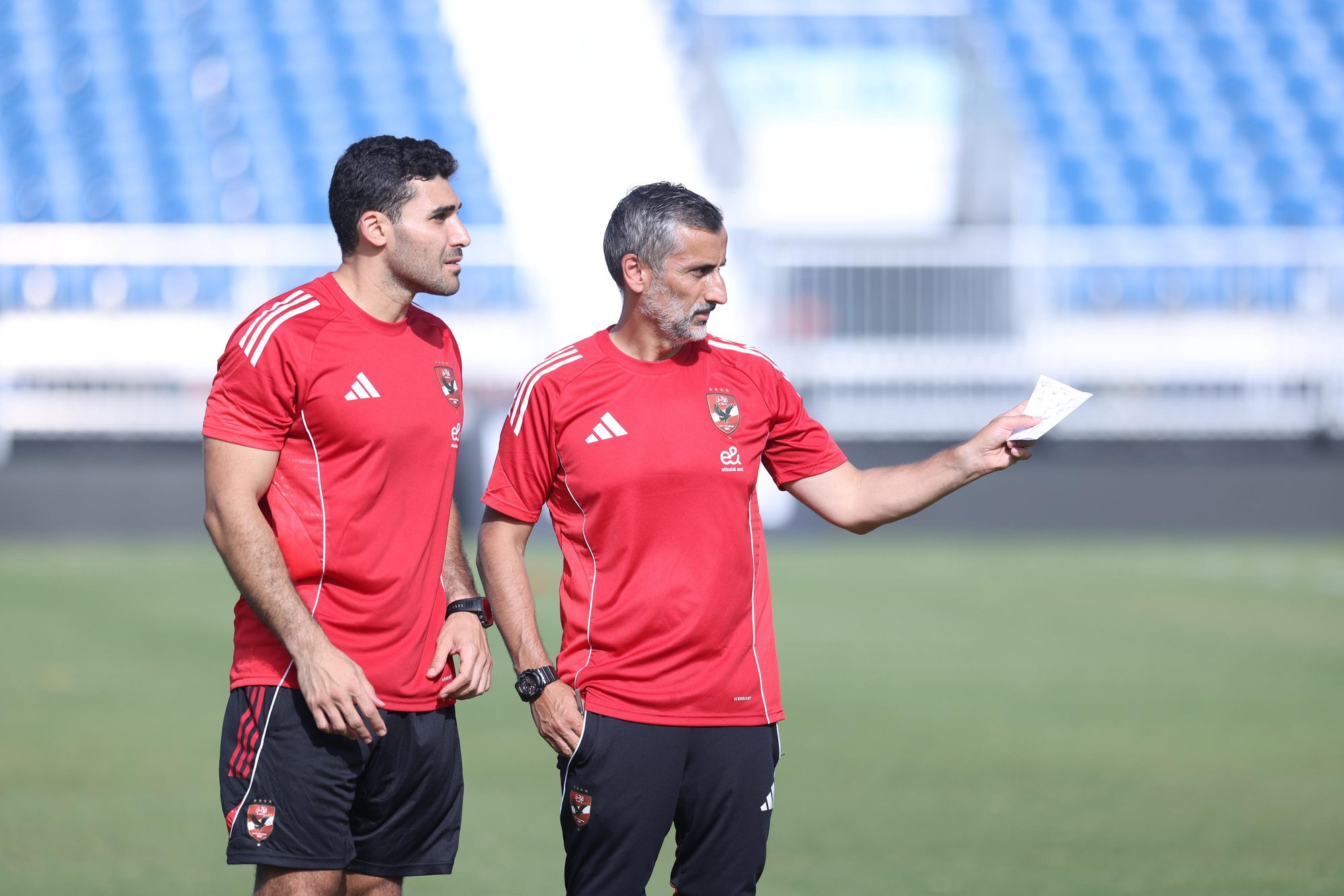 Shihy and the head coach going over the session plan